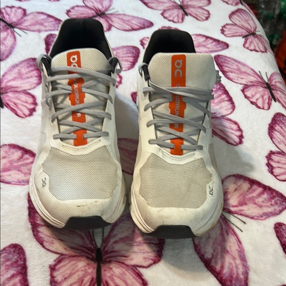 On Running White and Gray Shoes with Orange Highlights